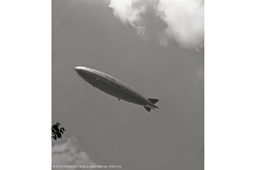 Ill-fated British rigid airship R101 flying over Wargrave Avenue in London, England on a trial run in the summer of 1930